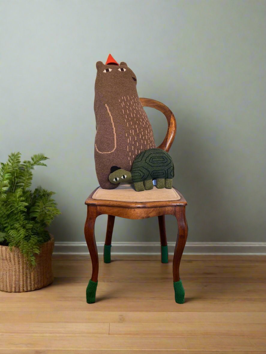 Bear stuffed animal designed by Donna Wilson, inspired by Jon Klassen, featuring a cozy, minimalist style. Knitted with lambswool.
