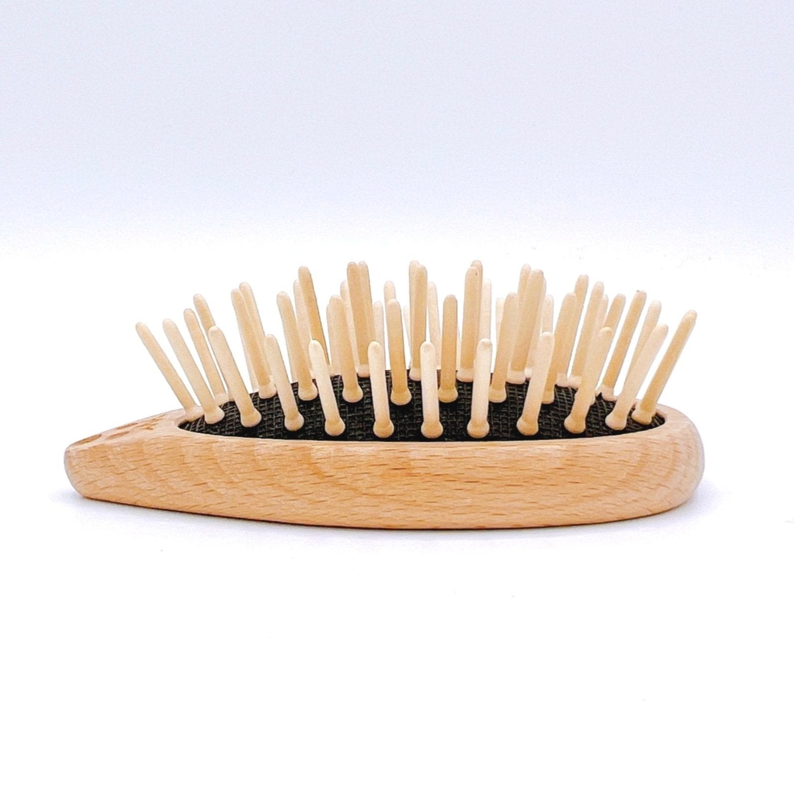 Redecker Hedgehog Travel Brush with wood bristles and a cute hedgehog design for compact and gentle hair care on the go.