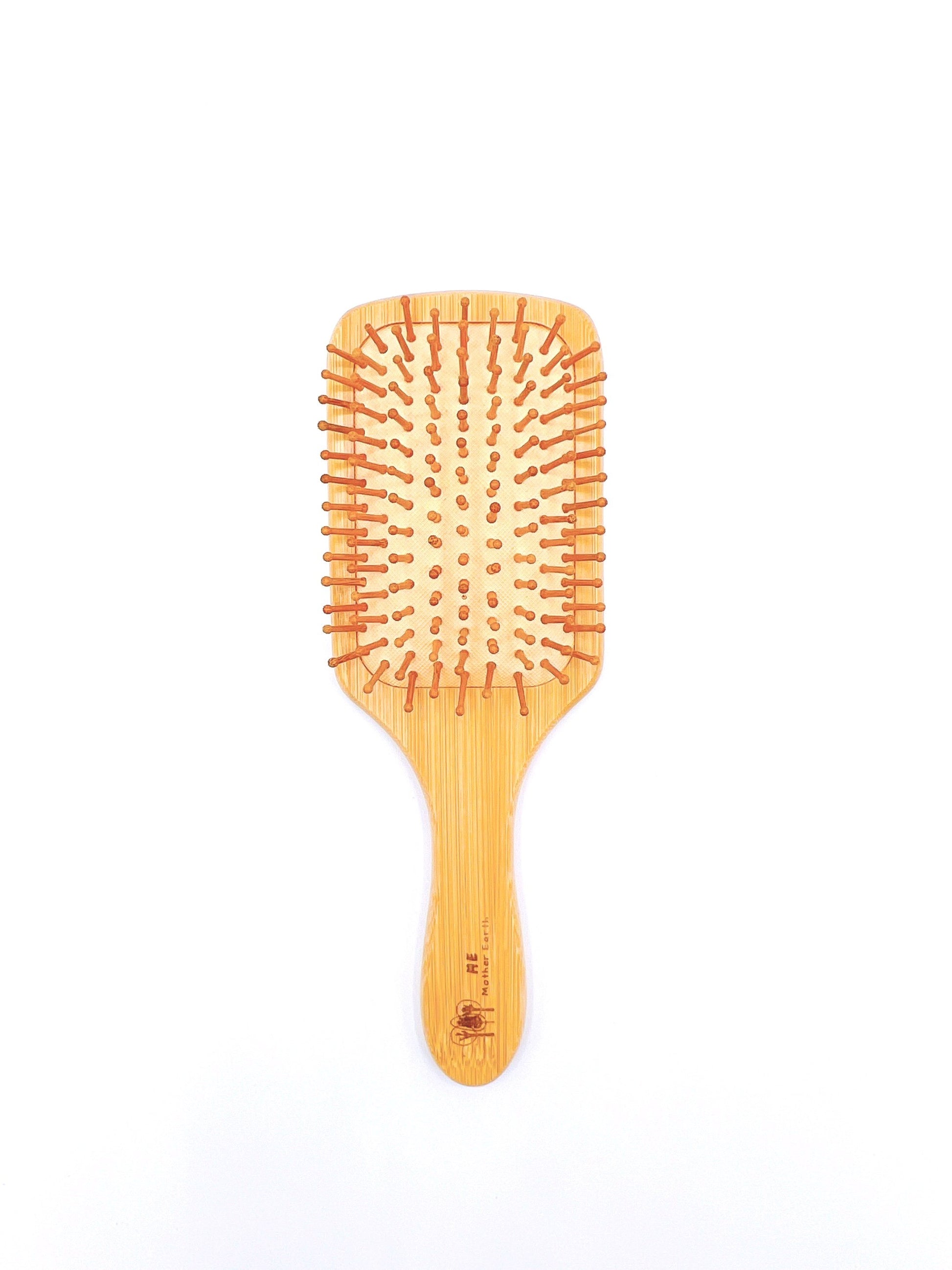 Sustainable Bamboo Paddle Hairbrush with bamboo bristles, ideal for detangling and massaging the scalp, suitable for all hair types.