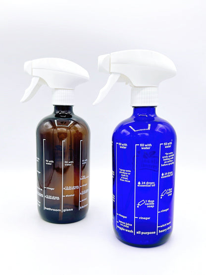 Cleaning Essentials Glass Spray Bottle in blue or amber, perfect for eco-friendly cleaning solutions with a stylish and reusable design.