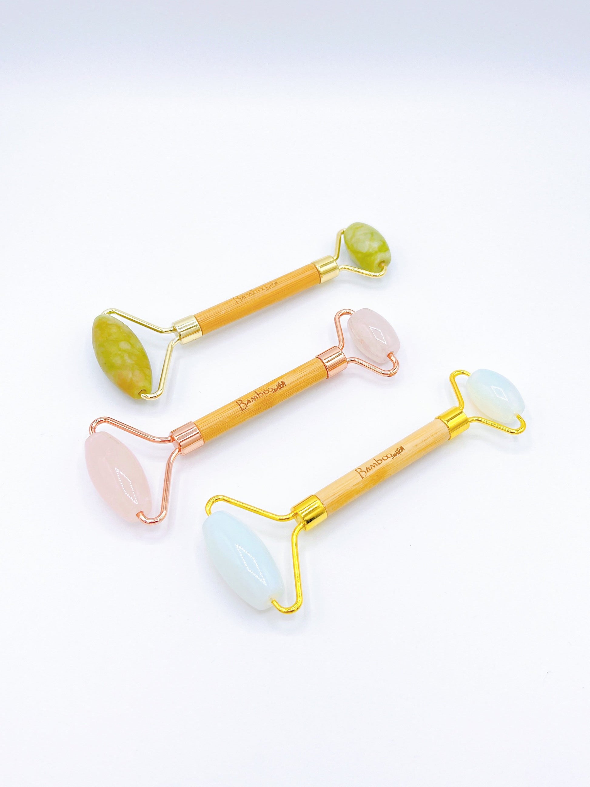 Facial roller made of smooth jade, rose quartz or opal helps reduce puffiness and improve circulation, with a comfortable handle for easy use.