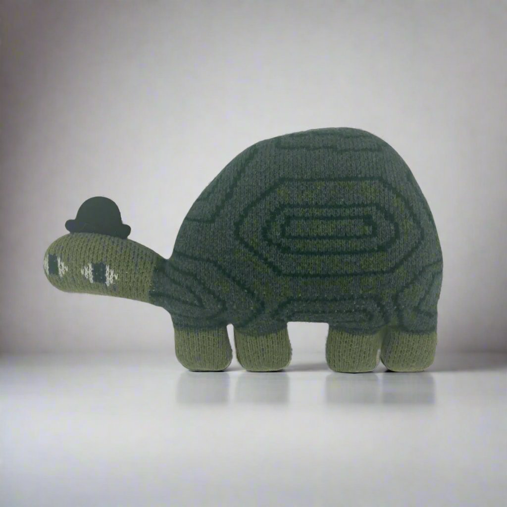 Hand-knitted Jon Klassen Turtle stuffed animal designed by Donna Wilson, featuring soft lambs wool material and whimsical details, perfect for children and collectors.