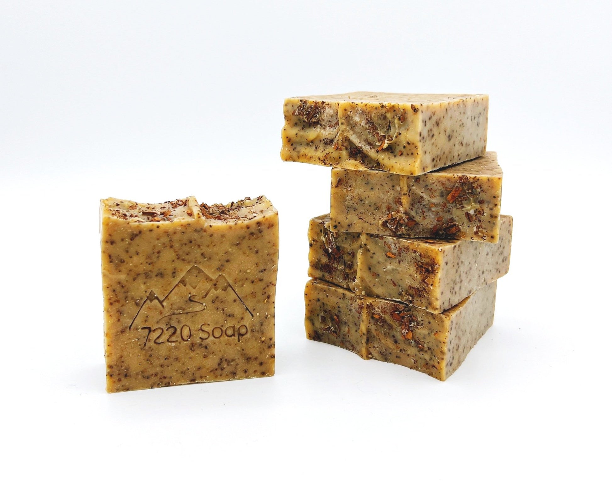 Exfoliating soap bar with ground coffee, perfect for removing dirt and grime while leaving skin smooth.