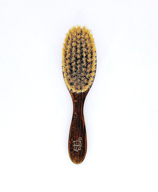 Eco-friendly cat brush with wooden handle and soft bristles, perfect for grooming your cat and reducing shedding.