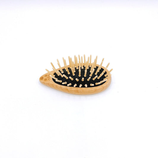 Redecker Hedgehog Travel Brush with wood bristles and a cute hedgehog design for compact and gentle hair care on the go.