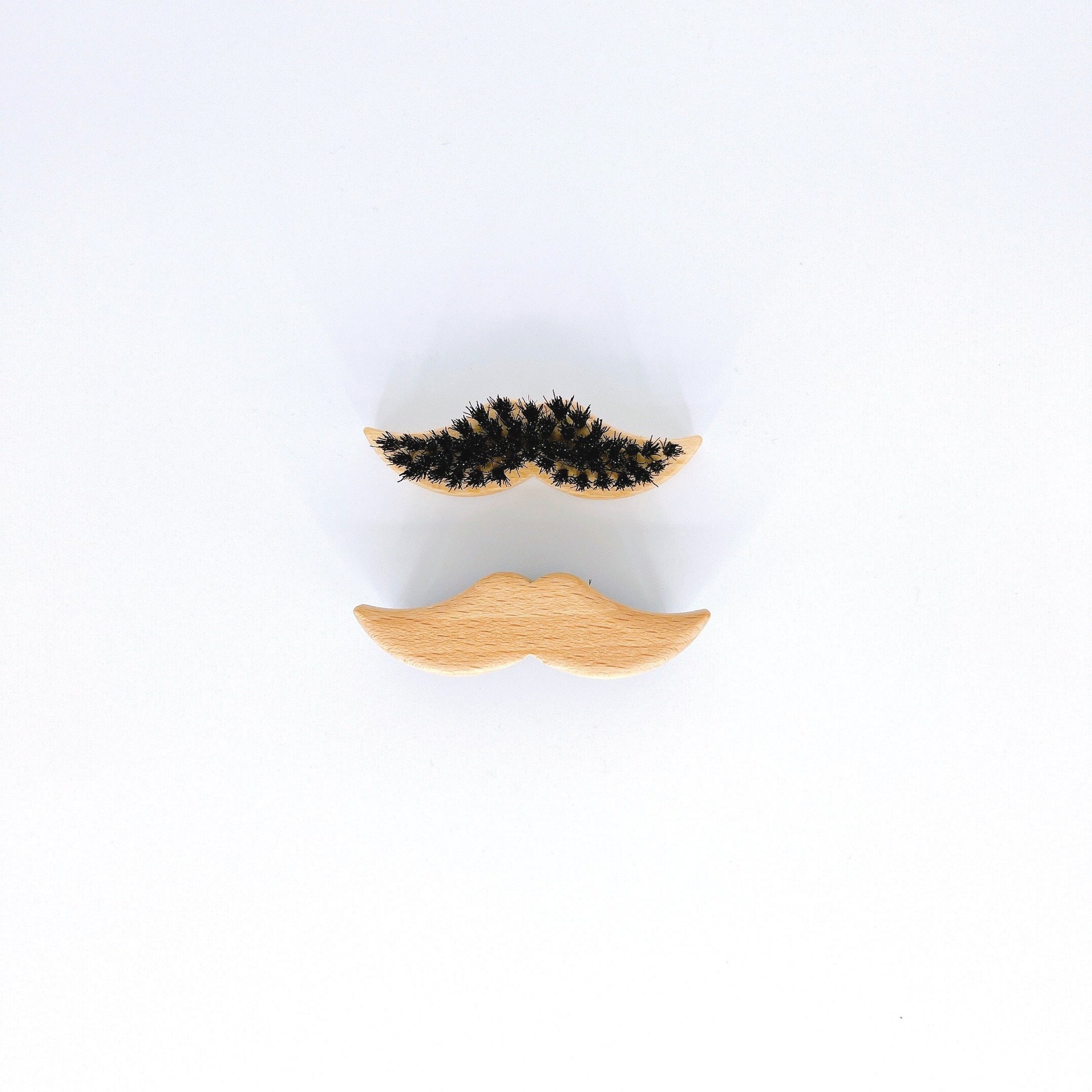 Small, handmade Redecker Mustache Brush with boar bristles, ideal for precise mustache and beard grooming.