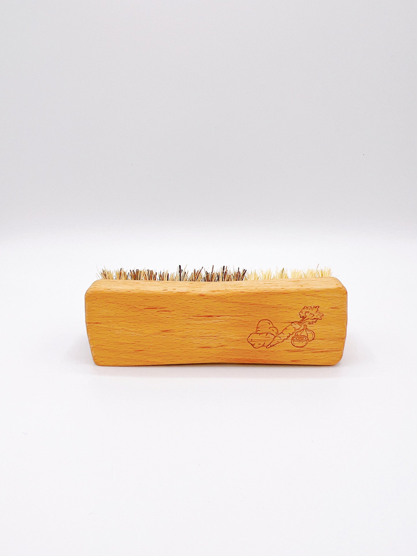 Eco-friendly Redecker veggie brush with natural bristles and a wooden handle. Ideal for cleaning fruits and vegetables.