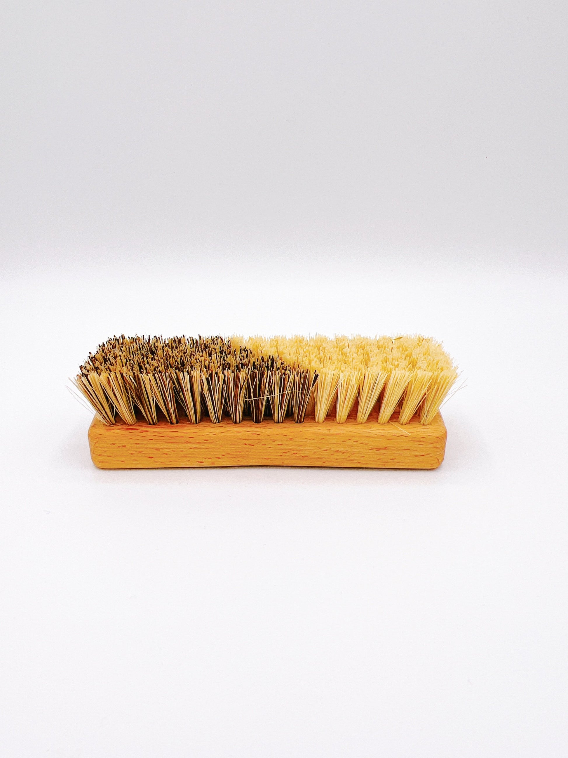 Eco-friendly Redecker veggie brush with natural bristles and a wooden handle. Ideal for cleaning fruits and vegetables.