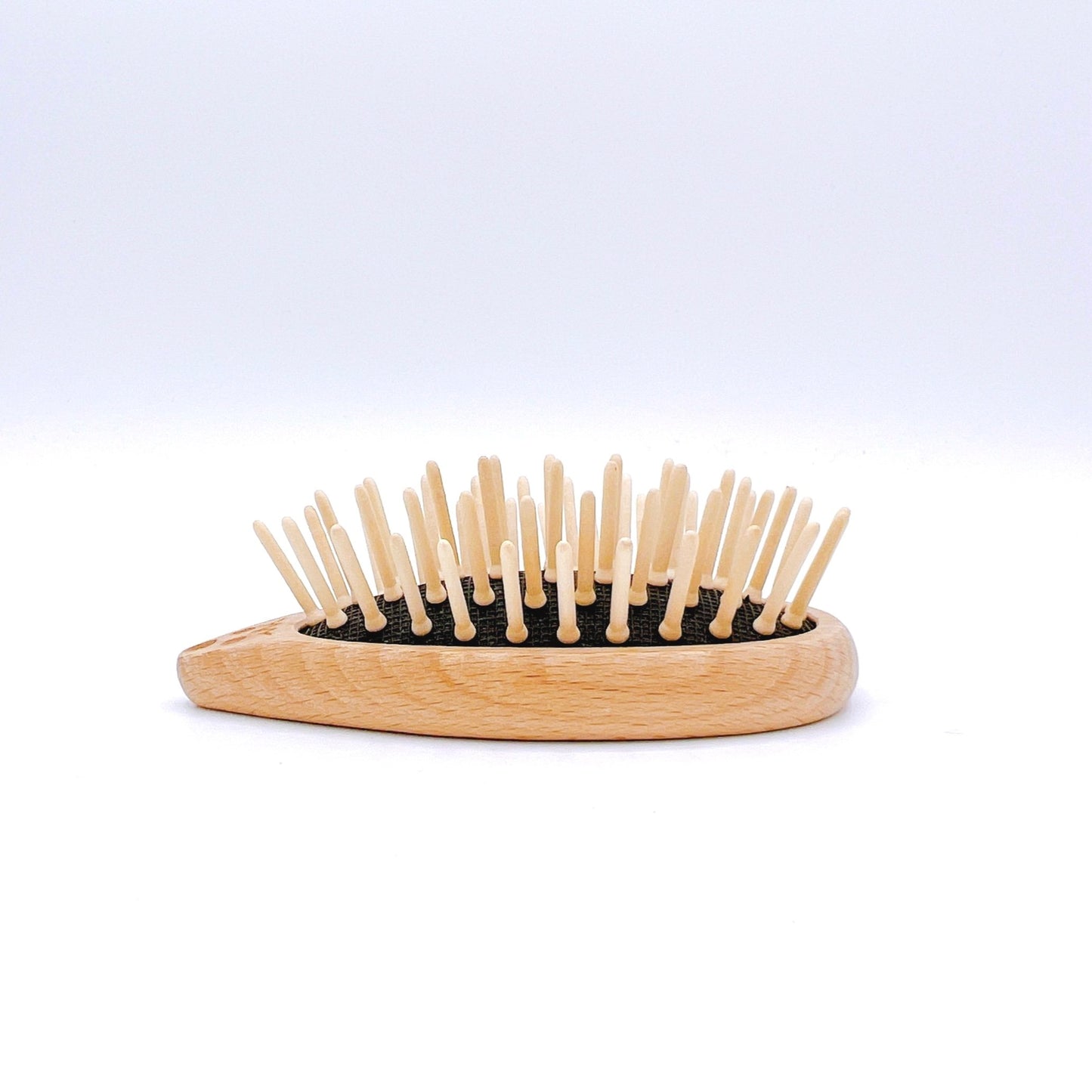 Redecker Hedgehog Travel Brush with wood bristles and a cute hedgehog design for compact and gentle hair care on the go.