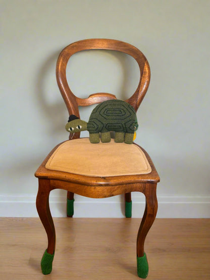 Hand-knitted Jon Klassen Turtle stuffed animal designed by Donna Wilson, featuring soft lambs wool material and whimsical details, perfect for children and collectors.